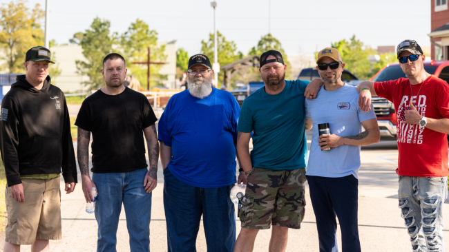 A group of veterans who are current residents of Camp Hope standing outside together at Camp Hope.