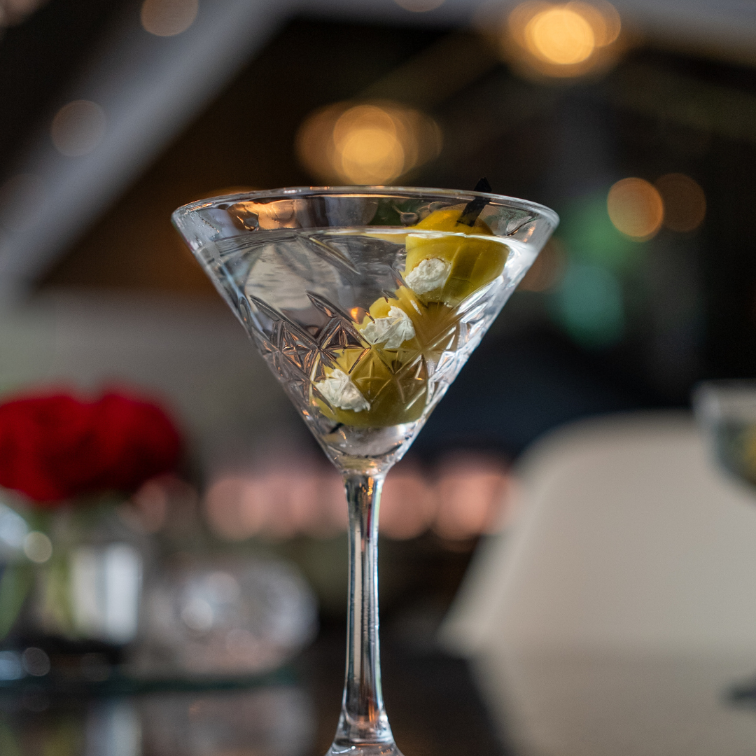Classic dinner martini made with vodka in a chilled crystal martini glass with blue cheese stuffed green olives
