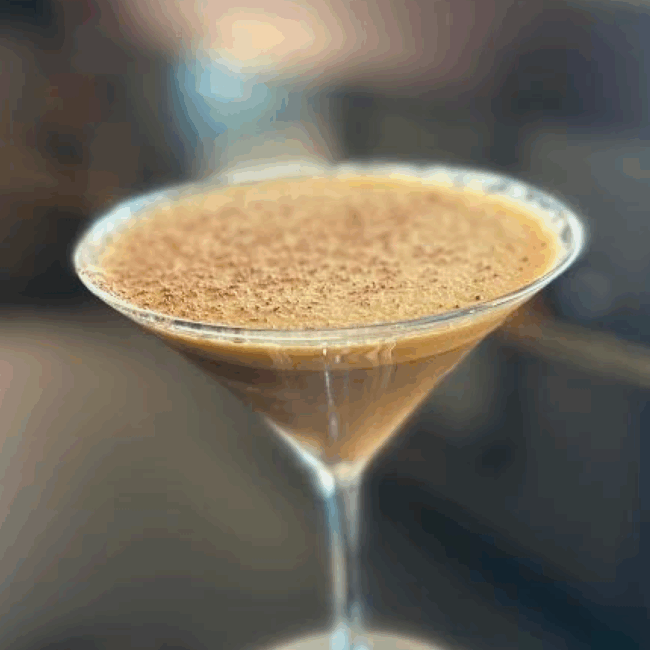 dessert espresso martini with a foamy top in a traditional martini glass