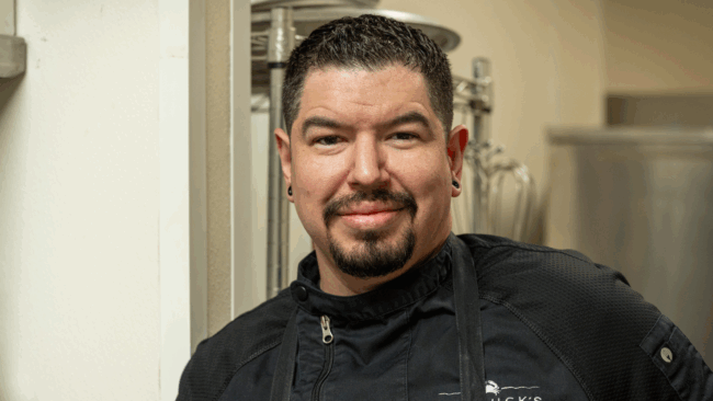 Chef Michael Cerny headshot he is wearing a black apron and black chef coat