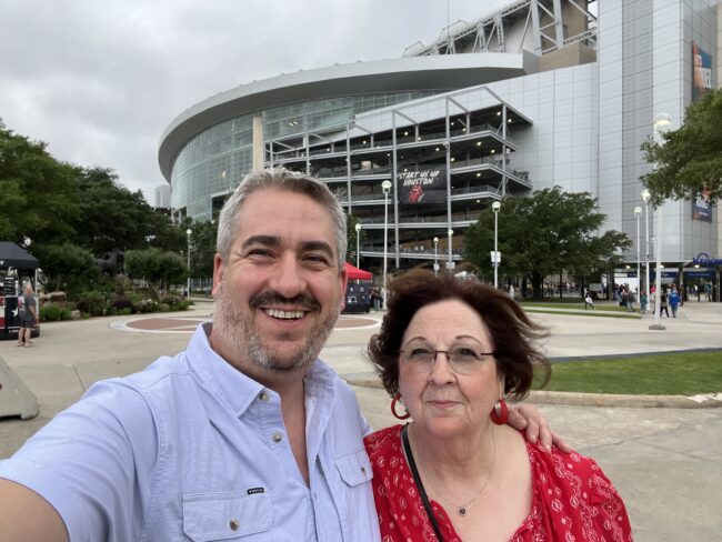 Ryan Studt with his mom standing outside of a concert venue