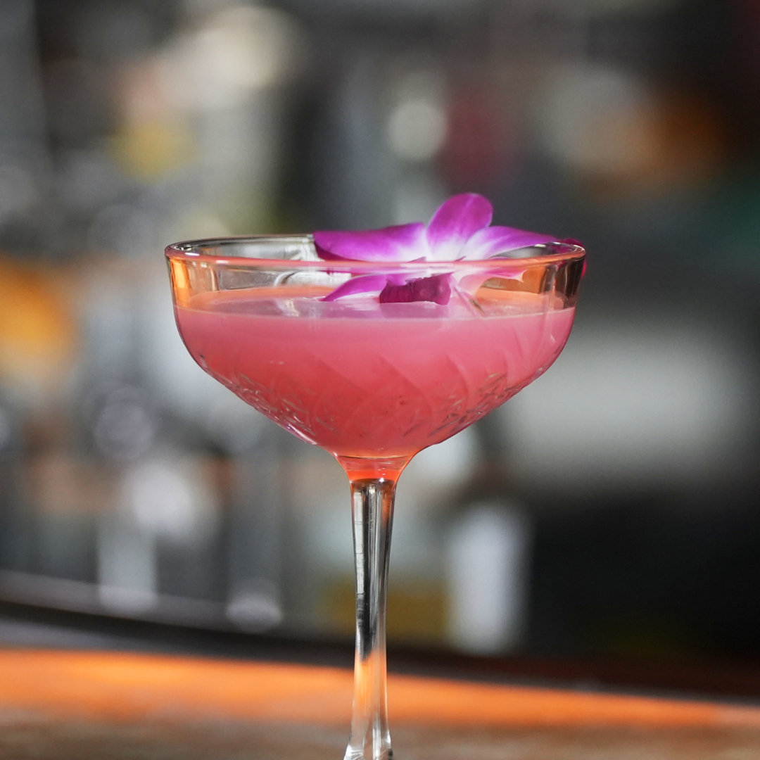 Refreshing non alcoholic Hibiscus Fresca cocktail featuring hibiscus, spiced orange, almond, fresh lemon and lime, finished with soda water.