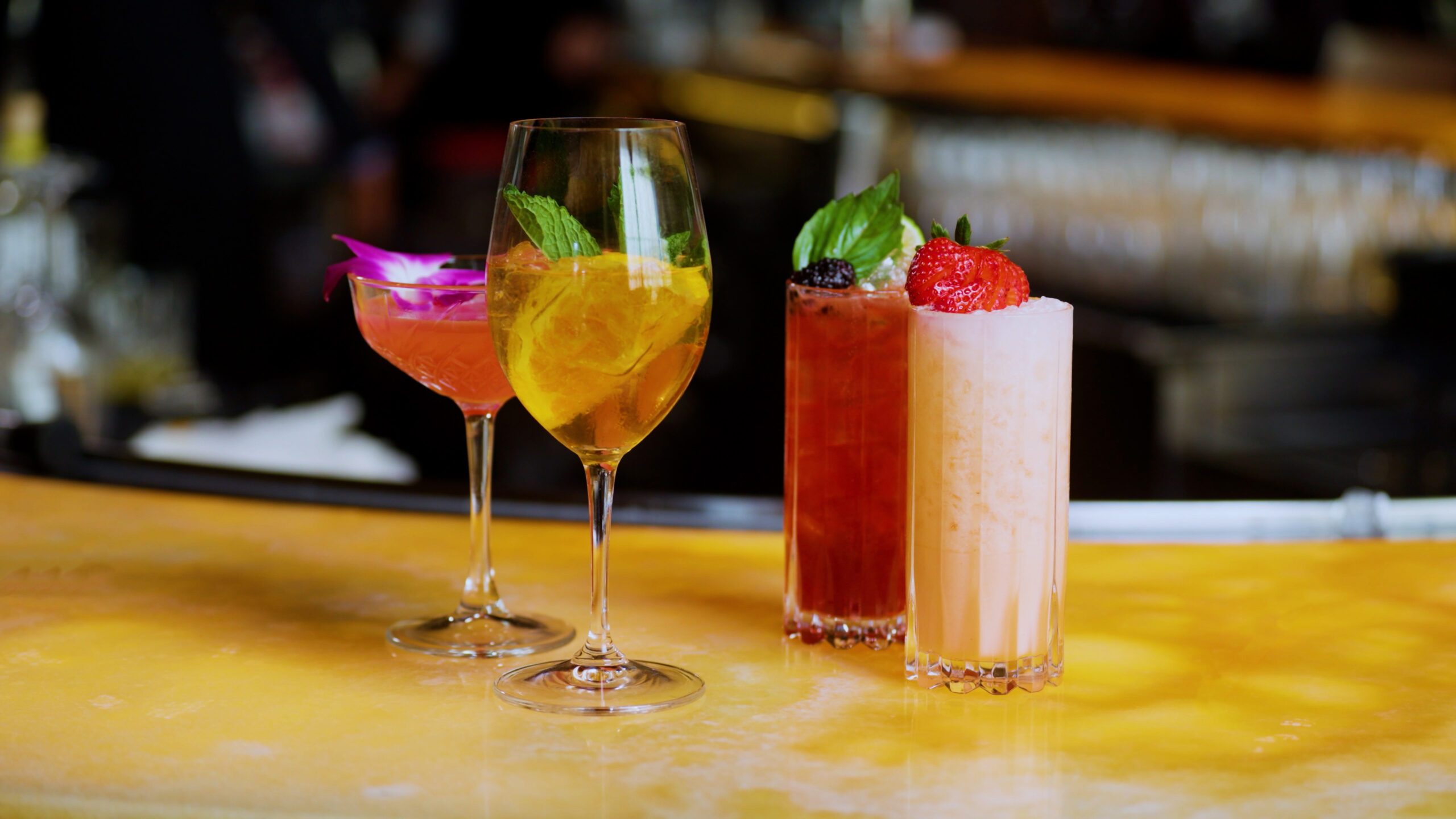 Assortment of handcrafted zero-proof cocktails featuring fresh fruit and herbs, offering a refined non-alcoholic option for Dry January.