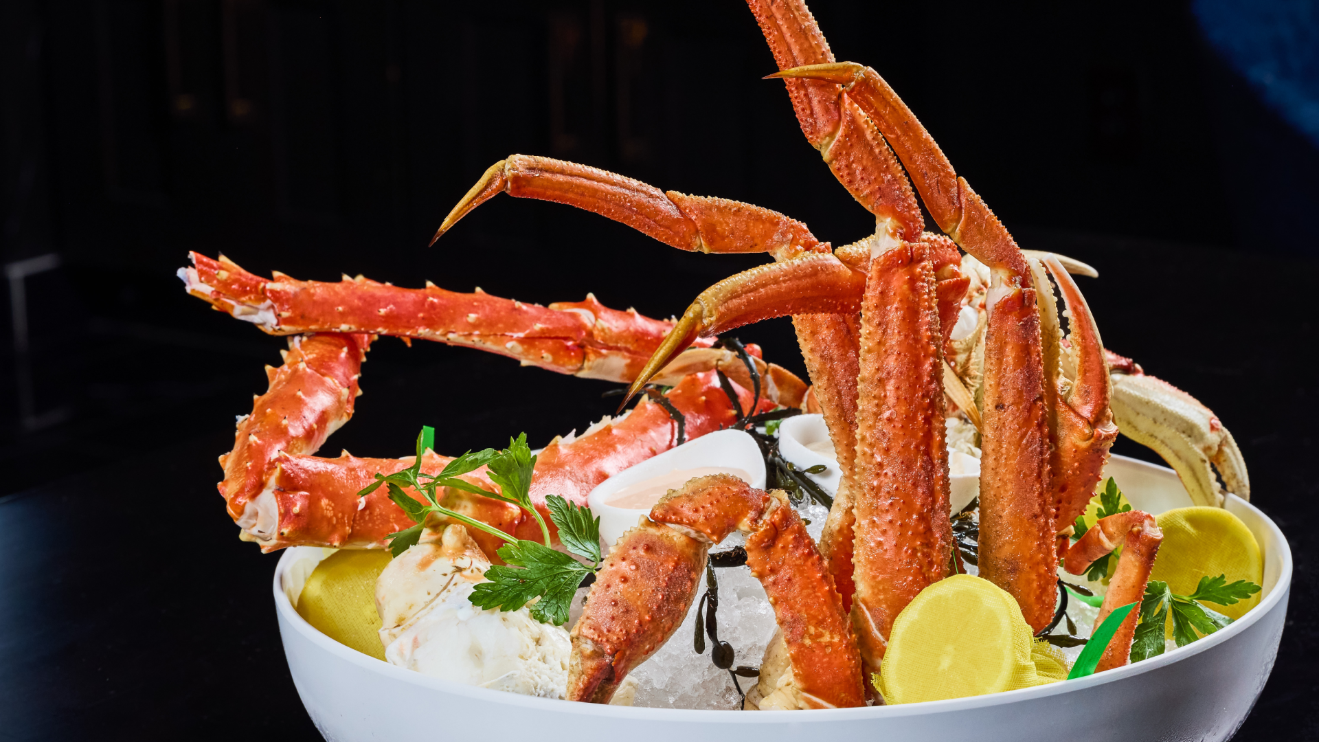 Truluck's Pacific and Alaskan crab platter featuring Red King Crab, Wild Bairdi snow crab, and Dungeness crab on ice — the summer crab program served during the 2026 FIFA World Cup