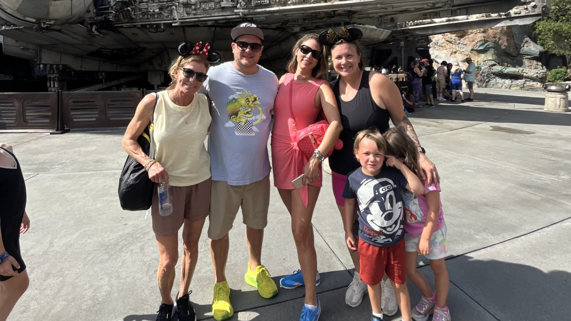 Johnny Griesedieck of Truluck’s Naples posing with family at a theme park attraction.